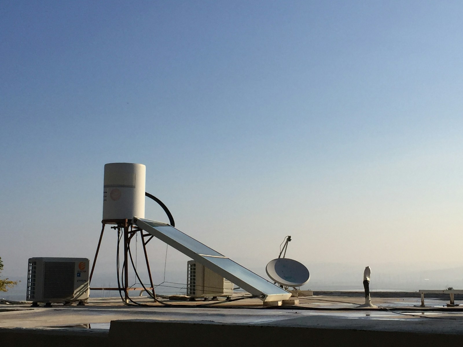 white satellite dish on gray concrete floor during daytime